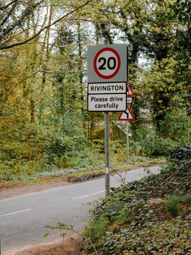 The twenty miles per hour speed limit sign by the road side in the village