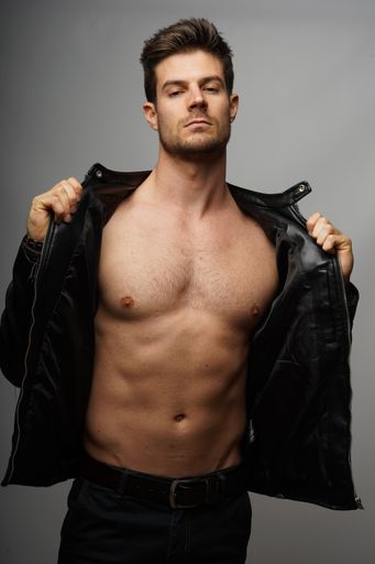 A portrait of a sexy shirtless man with a perfect body and leather jacket