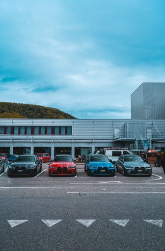 An airport parking lot with several cars parked on the side