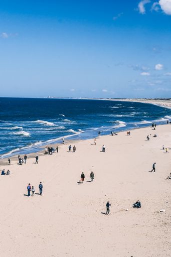 A scenic view of people on Scheveningen Beach in Den Haag, Netherlands