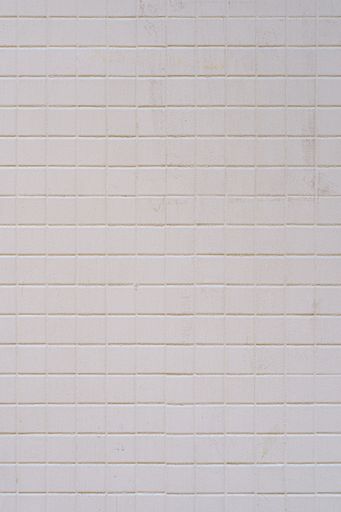 A Tiled wall covered with white paint. Abstract texture background.