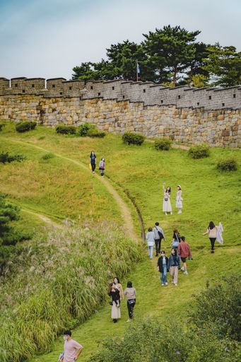 The tourists climbing Climbing Suwon's Hwaseong fortress in South Korea