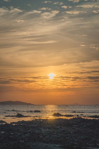 A beautiful shot of orange sunset over the rocky coast