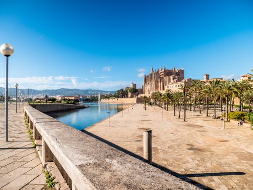A view of Palma La Seu cathedral by the sea in Spain, Mallorca against clear blue sky
