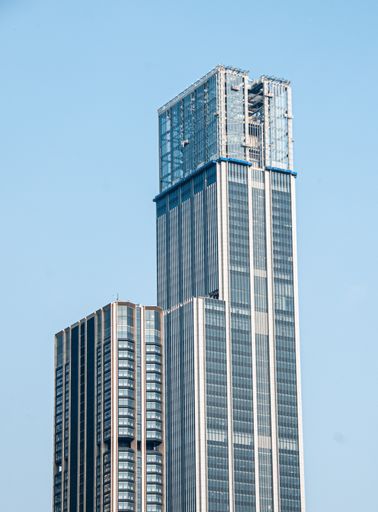Two high-rise buildings by waterfront in urban setting