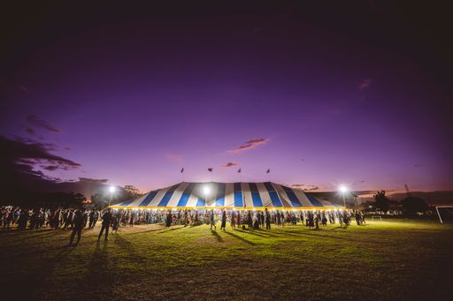 A giant circus tent illuminated by the setting sun