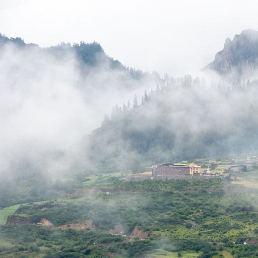 The houses of a small town surrounded by forests and a foggy cloud
