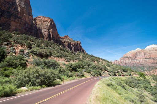 Empty road with some big mountains on one side of the road, close to Zion National Park, Utah
