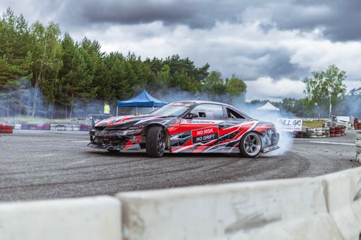 A Racing car performs burnout trick on track