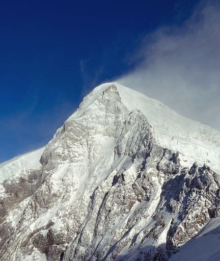 A snowy slope of a significant tall mountain