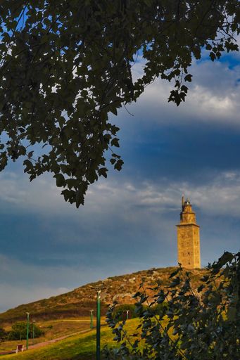 A vertical shot of the Tower of Hercules on top of a hill in Coruna, Galicia, Spain