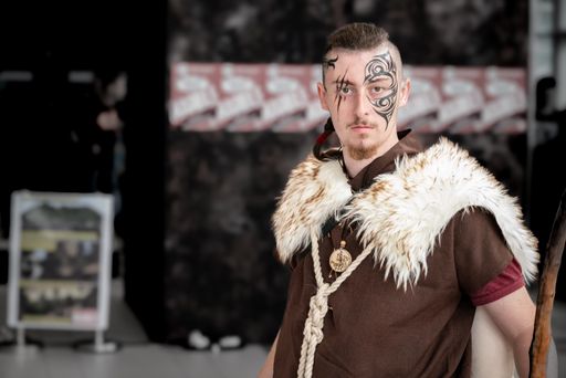 Male cosplayer dressed in a Viking outfit with face tattoos at Comic-Con