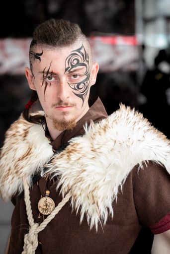 Portrait of a man with a boldface tattoo. Cosplay for Comic-con.