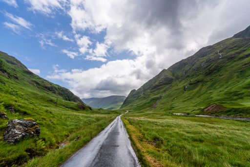 A winding road cuts through a mountain valley