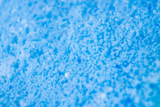 A close-up of a blue background of soap powder