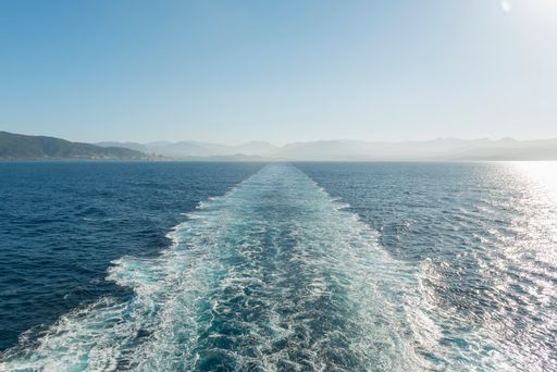 A wake line behind a boat from the ship's deck.