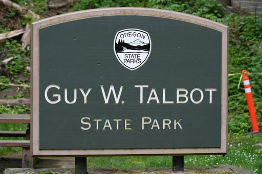 An entrance grey wooden information sign board at the Guy W. Talbot State Park at Latourell Falls Trailhead, Oregon