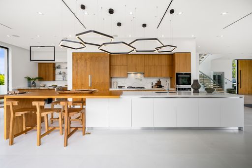 A Modern kitchen with central island and two stools at the counter