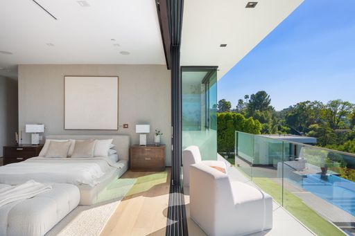 A Bedroom a balcony overlooking at a private pool