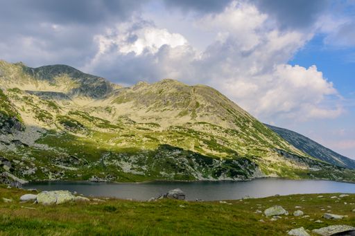 The Bucura lake nestled among the rolling hills in Retezat National Park, Romania
