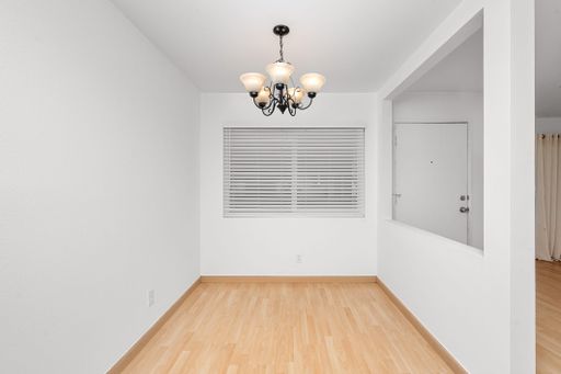 Modern living room with hardwood floors and white walls, minimalistic design