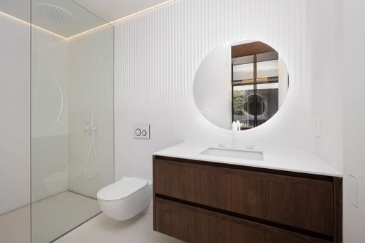 White vanity with mirror in bathroom