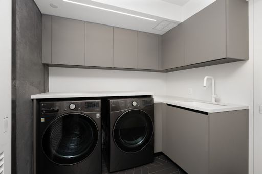 A contemporary kitchen with sink and AC unit