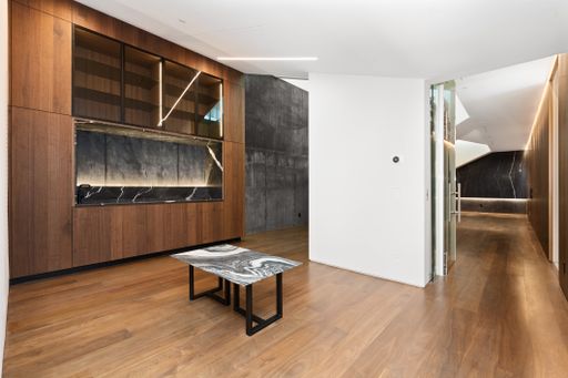 Empty room with wooden paneling and marble coffee table