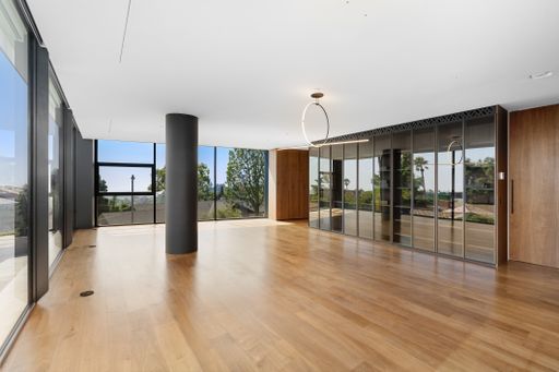 Spacious room with wooden floors and sliding doors