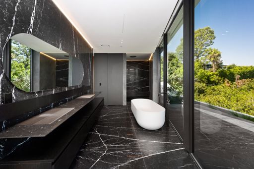 A modern bathroom with bathtub and large window