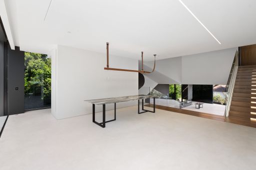 Spacious room with glass windows, view of patio and staircase