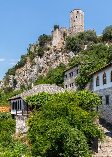 A scenic view of Pocitelj, Bosnia and Herzegovina on a sunny day at sunset