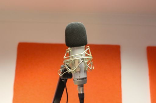 A closeup of a microphone in the studio.