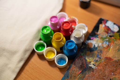 A top view of colorful paint pots for crafts