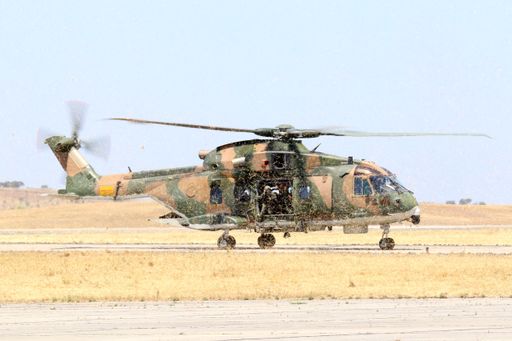 Military helicopter prepping for take-off on tarmac