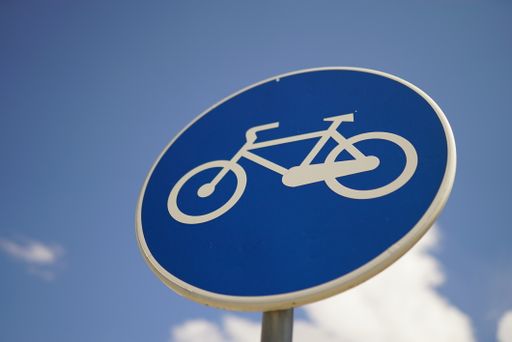 A selective focus shot of a bicycle path sign
