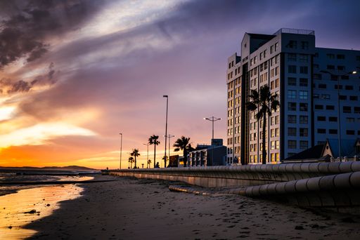A beautiful sunset along a beach promenade in Strand, Western Cape, South Africa
