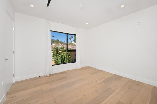 An empty room with white walls and a wooden floor. Home interior. California, USA