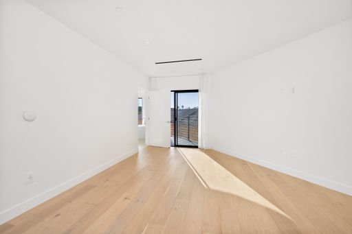 An empty room with white walls and a wooden floor. Home interior. California, USA