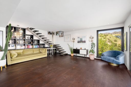 A spacious room with white walls and wood floors. California, USA