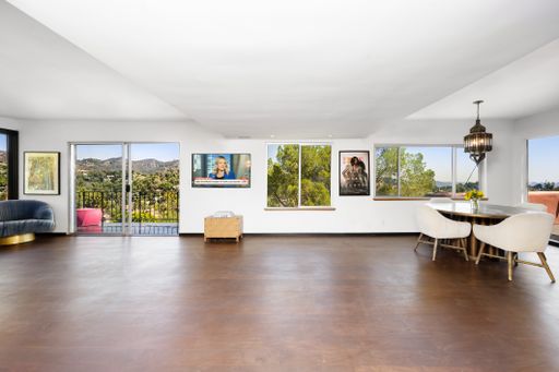 A modern living room with hardwood floors and glass doors. California, USA