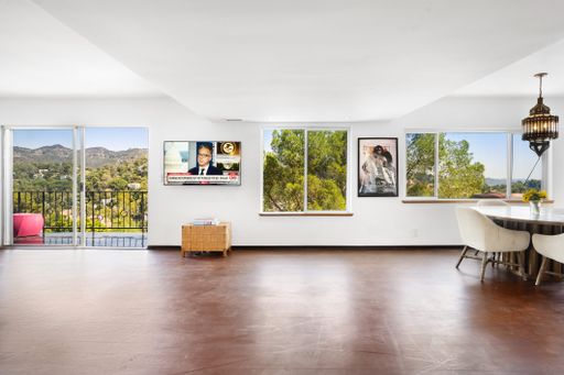 A modern living room with hardwood floors and glass doors. California, USA