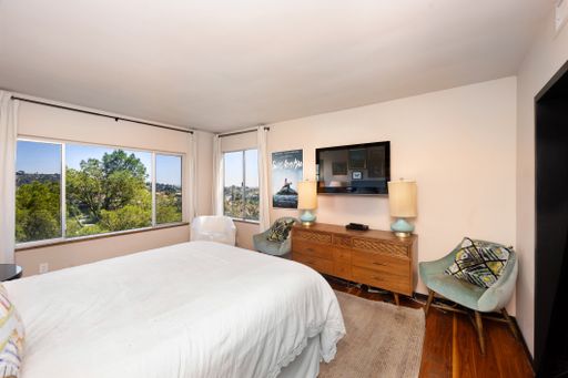 A spacious bedroom featuring a large bed next to a window. California, USA