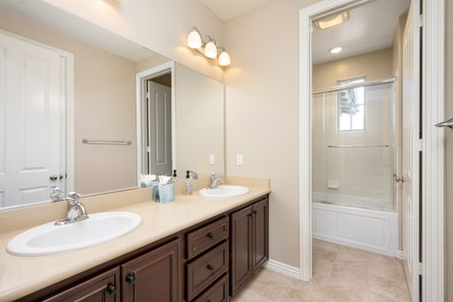 A bathroom with two white sinks and a shower in the background. California, USA