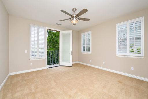 A room featuring windows with white blinds and a ceiling fan. California, USA