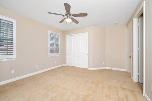 A room featuring windows with white blinds and a ceiling fan. California, USA
