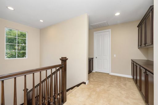 A staircase leading to the kitchen with dark brown cabinets. California, USA