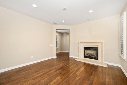 A spacious room with hardwood floors and a fireplace. California, USA