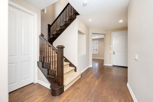 A staircase with a wooden banister in a spacious house. California, USA