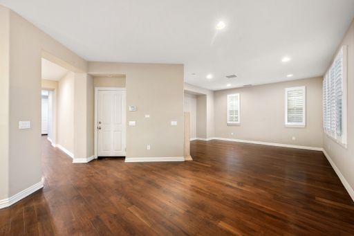 A spacious room with hardwood floors and windows with white blinds. California, USA